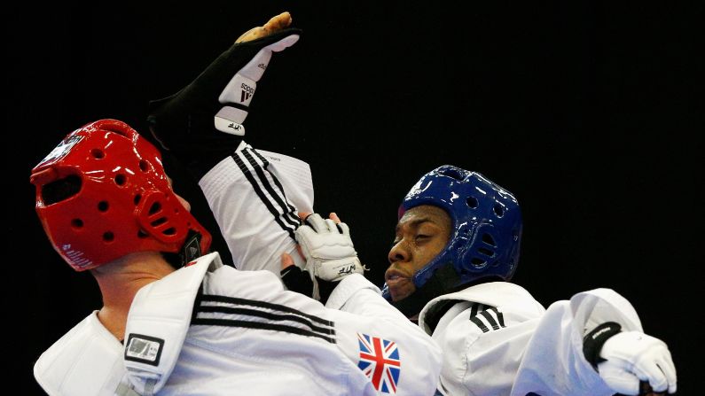 Lutalo Massop Muhammad, right, kicks Damon Sansum during a taekwondo match in Manchester, England, on Sunday, October 18.