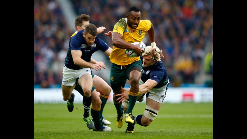 Australian rugby player Tevita Kuridrani breaks away from Scottish players during a Rugby World Cup quarterfinal match on Sunday, October 18. Australia advanced with a 35-34 victory.