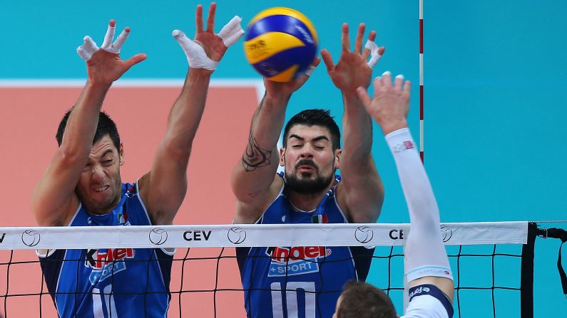 Finland's Olli-Pekka Ojansivu spikes the ball against Italians Simone Buti, left, and Filippo Lanza during a European Championship match Tuesday, October 13, in Busto Arsizio, Italy. Italy won 3-0 and eventually finished the tournament in third place. France defeated Slovenia in the final.