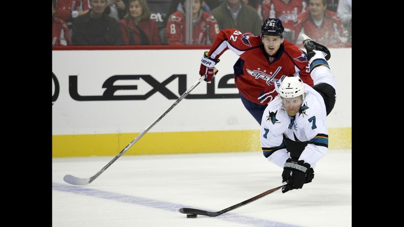 San Jose defenseman Paul Martin reaches for the puck while playing an NHL game in Washington on Tuesday, October 13.
