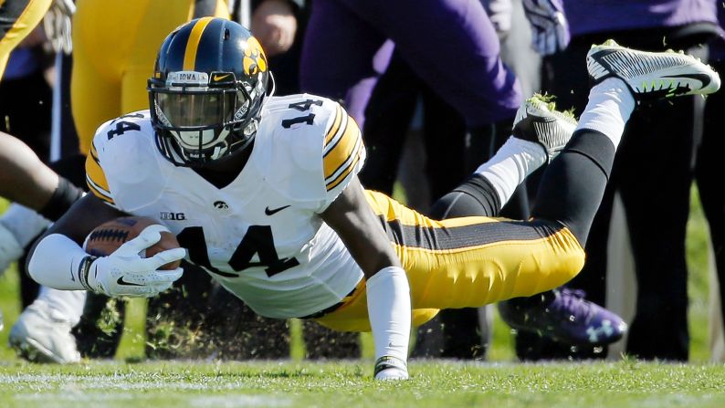 Iowa's Desmond King falls to the ground after intercepting a pass at Northwestern on Saturday, October 17. King has five interceptions this year for the undefeated Hawkeyes.