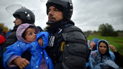 Slovenian police helped some of the people who were stuck in cold and wet weather in Trnovec. 