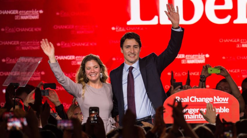 Canadian Liberal Party leader Justin Trudeau and his wife Sophie wave on stage in Montreal on October 20, 2015 after winning the general elections.    AFP PHOTO/NICHOLAS KAMM        (Photo credit should read NICHOLAS KAMM/AFP/Getty Images)