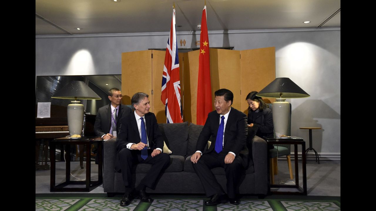 British Foreign Secretary Philip Hammond sits with Xi at Heathrow Airport after Xi's arrival on Monday, October 19.