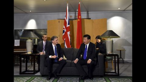 British Foreign Secretary Philip Hammond sits with Xi at Heathrow Airport after Xi's arrival on Monday, October 19.