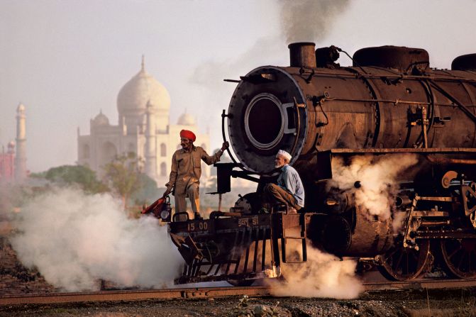 The gleaming white marble of the Taj Mahal is vividly contrasted against the dirty black steam of a passing train, in this 1983 photograph. <br /><br />Scottish historian and writer of numerous books on India, William Dalrymple, sees  McCurry as a master at capturing India's "extraordinary contradictions."<br /><br />"Perhaps most stark among the extremes McCurry illustrates are those between India's rich and poor," says Dalrymple in his written introduction to "India."<br /><br />"We see the landowner with his hunting trophies pinned to the wall, and we see the beggar children dying beside the railway tracks, invisible to the passengers on the train; we see the soaked beggar children fingering desperately at the windows of the taxi; and we see the Bombay elite, coiffed and laundered, with their fleets of vintage cars and uniformed chauffeurs..."
