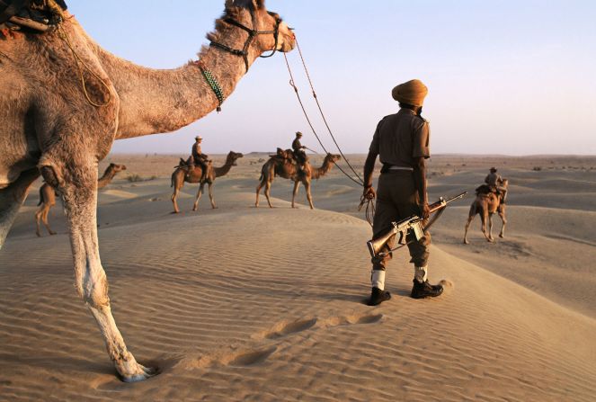 Here, India's Camel Corps patrol desert near the Pakistan border, in 1996.<br /><br />"McCurry's India is, above all, a world of paradox," explains Dalrymple.<br /><br />"It is where border guards ride camels through the timeless deserts of the Thar, carrying the latest in modern M-16 high-velocity assault rifles."<br />
