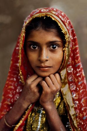 McCurry's most famous image is undoubtedly his portrait of an "Afghan Girl" which graced the cover of National Geographic in 1985.<br /><br />It's not so dissimilar to this striking portrait of a "Girl in Red," taken in Jaipur, Rajasthan, in 1983.<br /><br /><br />