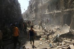 Syrians check the rubble following an airstrike in Aleppo last month.