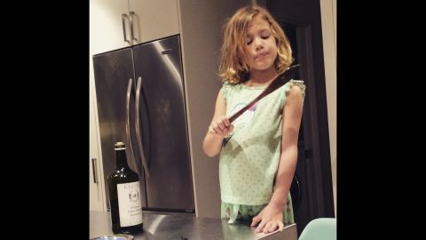 Cooking is one of Scarlett's favorite activities. She's seen here licking the spoon after making pesto sauce. 