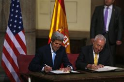 U.S. Secretary of State John Kerry, left, and Spanish Foreign Minister Jose Manuel Garcia Margallo sign agreements Monday, October 19, relating to the cleanup of the Palomares disaster of 1966.