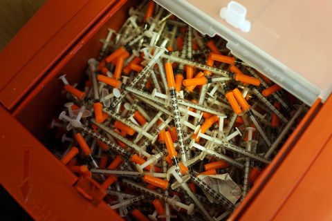 Needle exchange is another strategy used to reduce infections among drug users. Pictured, used syringes are viewed at a needle exchange clinic in, Vermont, USA.