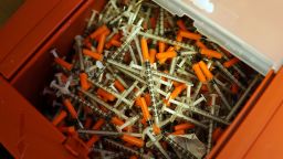 Needle exchange is another strategy used to reduce infections among drug users. Pictured, ysed syringes are viewed at a needle exchange clinic in, Vermont, USA.