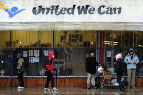 It's located in the Downtown Eastside area of Vancouver, a neighborhood known for its poverty and deprivation. Pictured, a group of homeless and poor people seek shelter from the rain outside a store.