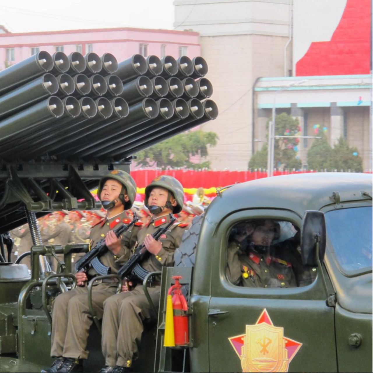 Young members of North Korea's military ride artillery through Pyongyang.