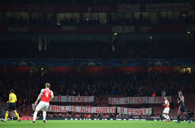 Bayern Munich fans hold a banner as they protest in the stands against the cost of tickets, at the beginning of the UEFA Champions League football match between Arsenal and Bayern Munich at the Emirates Stadium in London. 