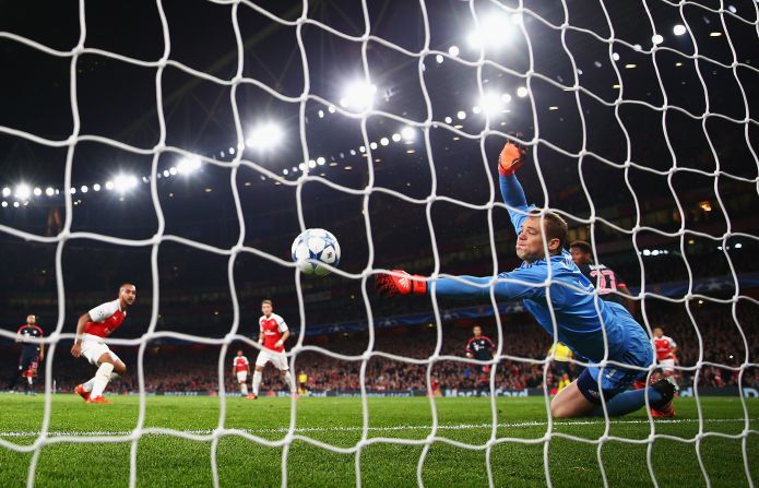 Manuel Neuer of Bayern Munich makes a save from Theo Walcott of Arsenal during the UEFA Champions League Group F match between Arsenal FC and FC Bayern Munchen at Emirates Stadium.