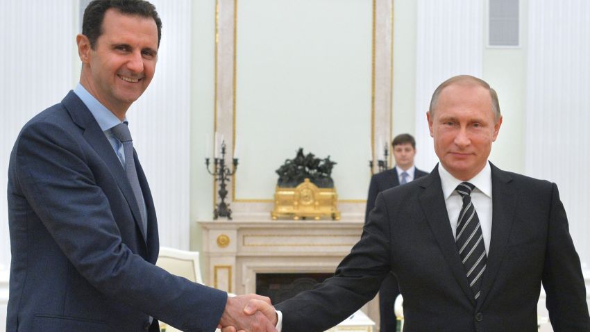 Russian President Vladimir Putin (R) shakes hands with his Syrian counterpart Bashar al-Assad (L) during a meeting at the Kremlin in Moscow on October 21, 2015. Assad, on his first foreign visit since Syria's war broke out, told his main backer and counterpart Putin in Moscow that Russia's campaign in Syria has helped contain "terrorism". AFP PHOTO / RIA NOVOSTI / KREMLIN POOL / ALEXEY DRUZHININ        (Photo credit should read ALEXEY DRUZHININ/AFP/Getty Images)