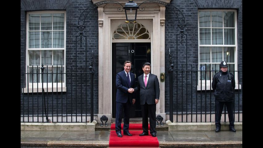 Britain's Prime Minister David Cameron greets Xi as he arrives at 10 Downing Street.