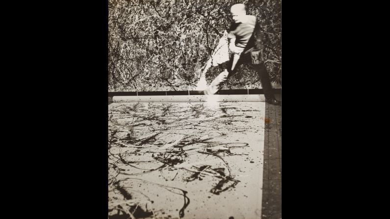 Abstract artist Jackson Pollock adorns one of his famous giant canvases in his studio in 1950. The kinetic shot captures the athleticism of Pollock's painting style. The black-and-white film does not allow a look at his color scheme, however.