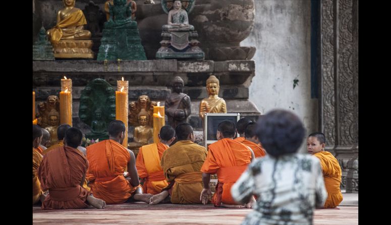 At small Buddhist temples dotted throughout the ruins of Angkor Thom, monks pray throughout the day and locals and tourists pay their respects.