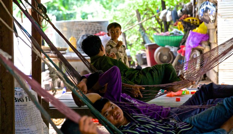  A father talks with his son while lying in a hammock outside their home in Siem Reap. This photo was snapped when Bruer was weaving through the temples. "Many families live within feet of many of the ancient structures, often converting their homes into makeshift stores selling bottled water and T-shirts to visitors," says Bruer.