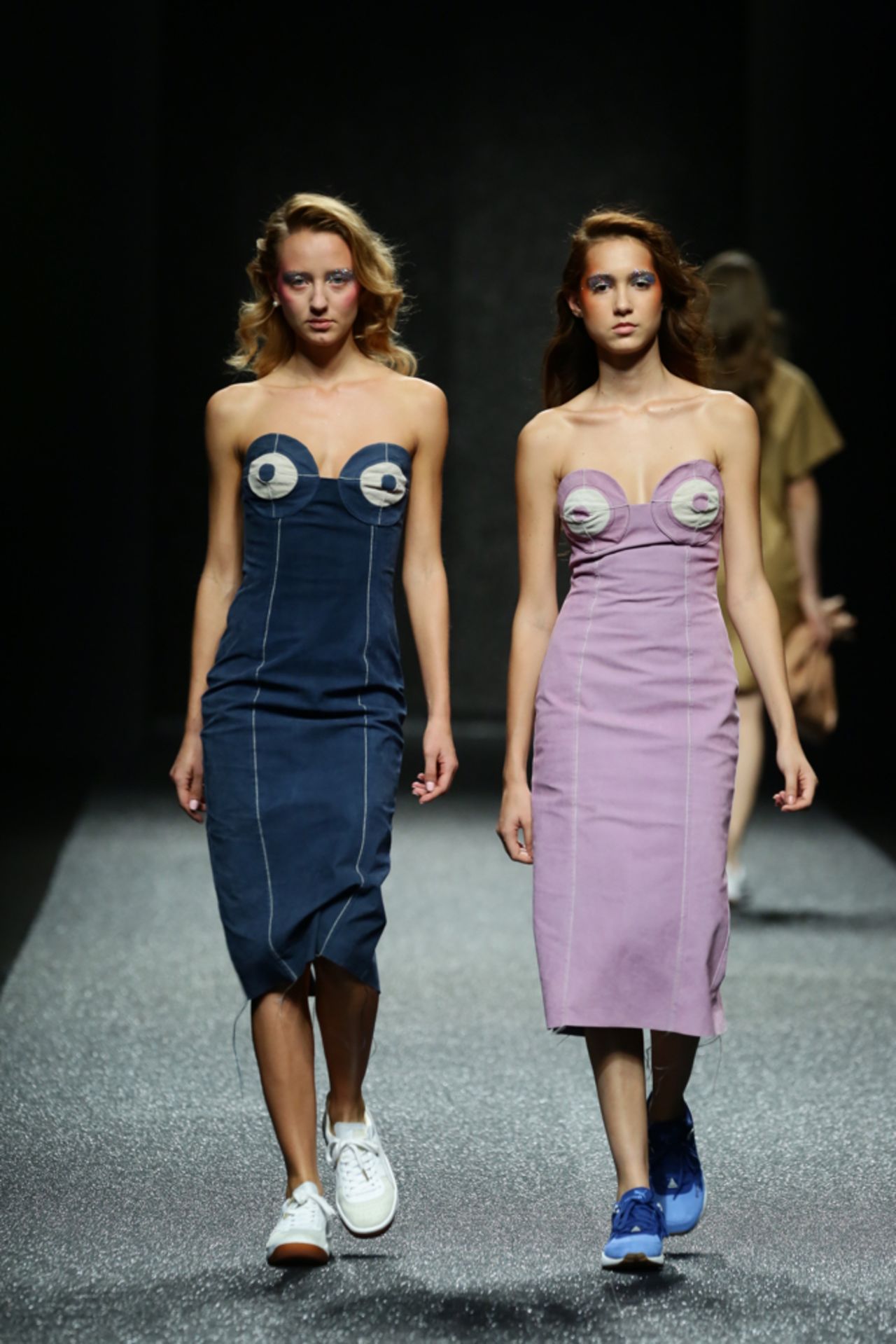 The collection showed practical yet fun outfits, like these denim bustier dresses paired with sneakers.