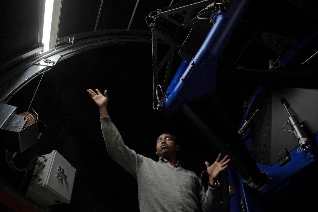 Ghion Ashenafi, an electrical engineer at the Entoto Observatory and Research Center, inside one of the center's telescopes.