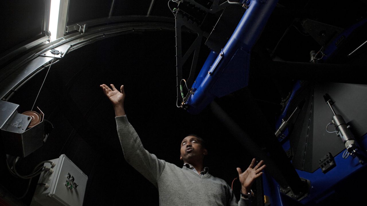 Ghion Ashenafi, an electrical engineer at the Entoto Observatory and Research Center, inside one of the center's telescopes.
