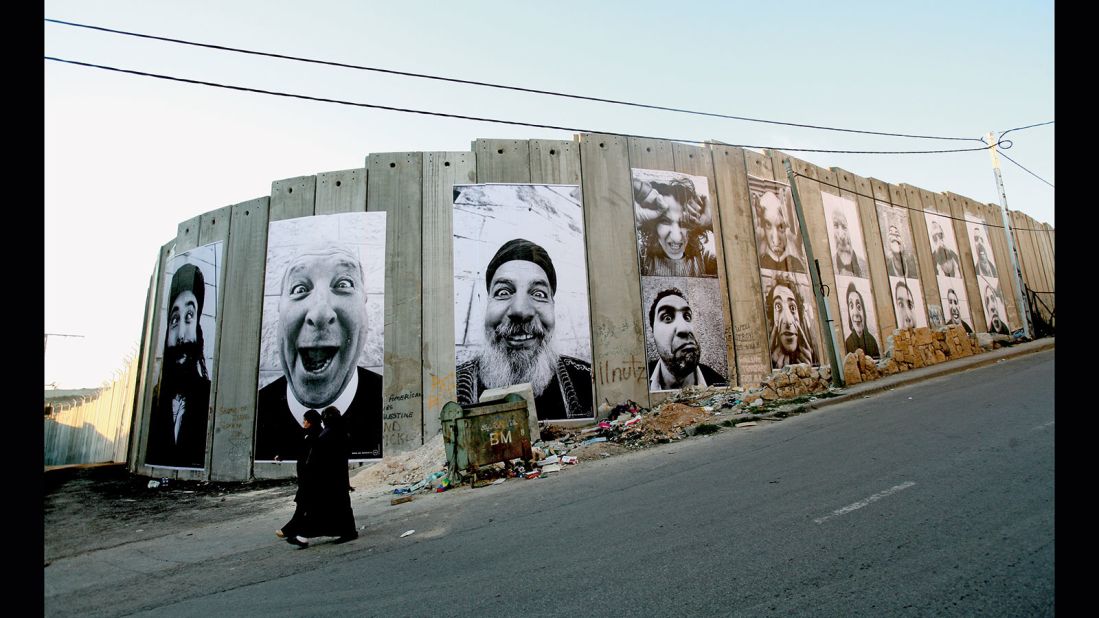 JR and his friend Marco went to the Middle East in 2005 and captured a series of photographs of Palestinian and Israeli people they met on their travels. In 2007, JR paired these photos face to face and plastered the images on walls in cities across Israel and the Palestinian territories. This photo was taken in the West Bank town of Bethlehem.