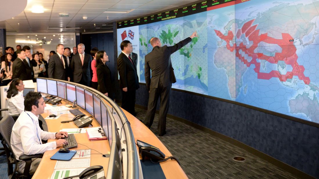 Xi views satellite coverage screens in the Network Operation Centre control room during a visit to Inmarsat, a satellite telecommunications company, in London on October 22.