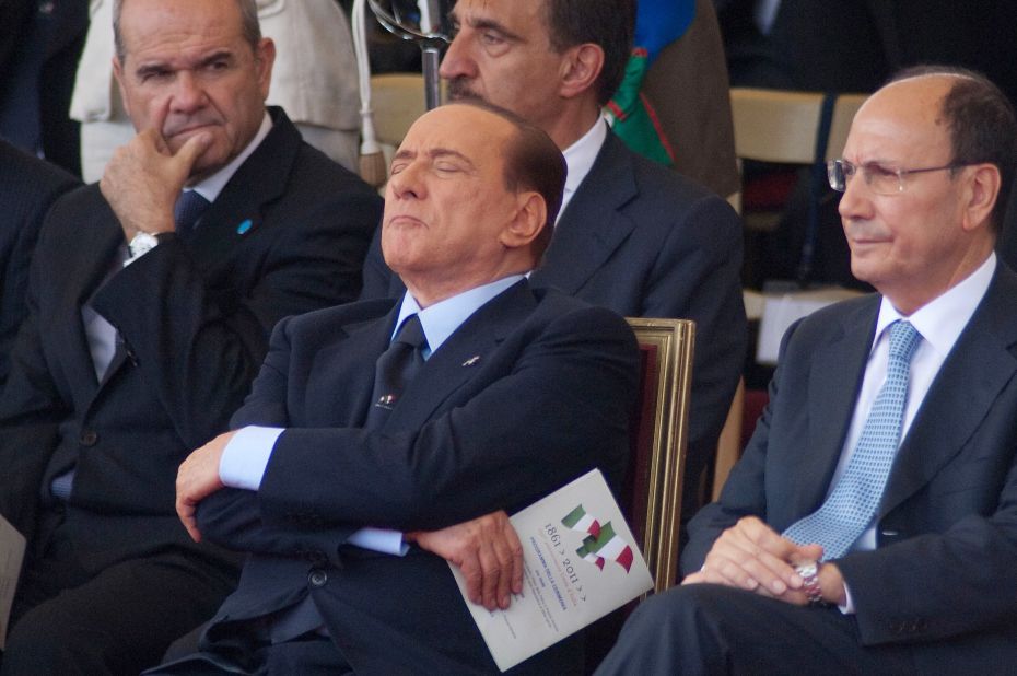 Former Italian Prime Minister Silvio Berlusconi (C) takes a nap during a military parade to mark the the 150th anniversary of Italian unification in Rome in June 2011.