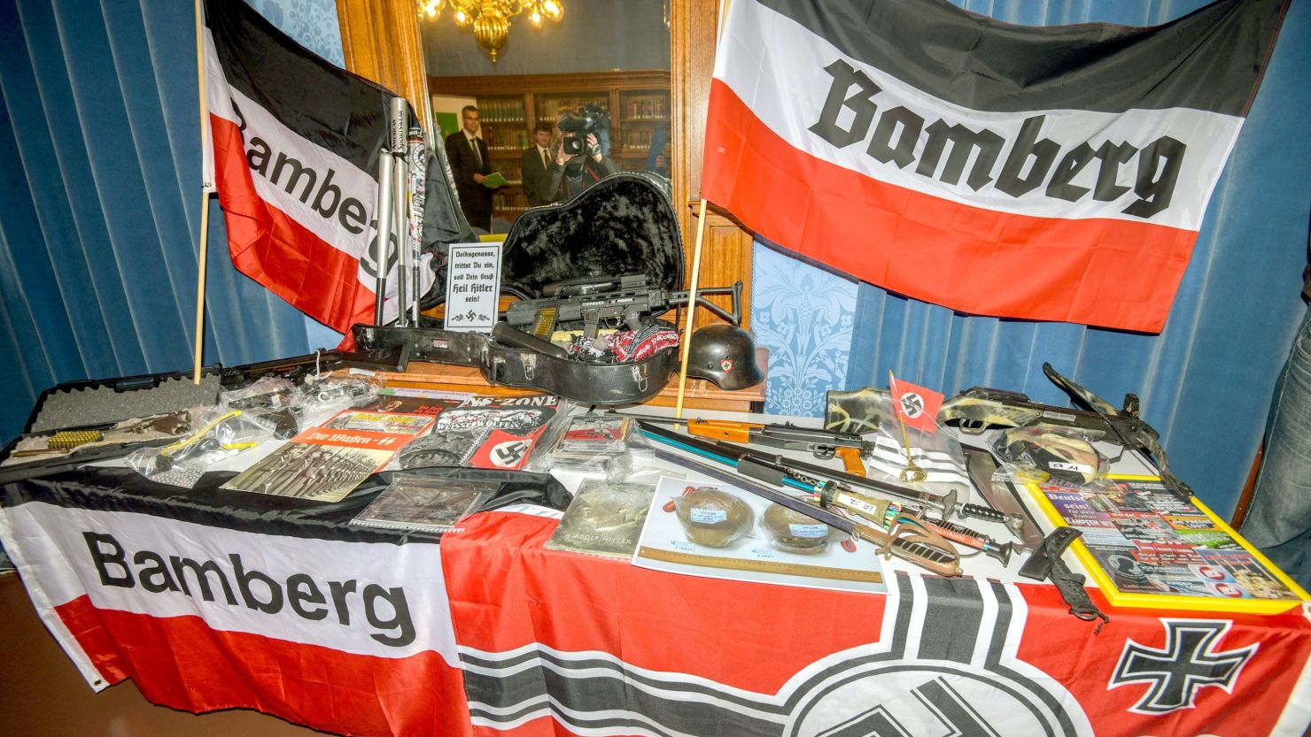 Seized firearms, other weapons, paintball guns and Nazi flags on display during a press conference of German police in Bamberg, southern Germany.