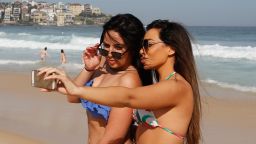 SYDNEY, AUSTRALIA - OCTOBER 31:  Friends take a selfie as they enjoy the warm weather down at Bondi Beach on October 31, 2014 in Sydney, Australia.  Australia is expecting much hotter temperatures than usual for the next three months.  (Photo by Daniel Munoz/Getty Images)