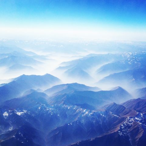 <strong>3. Don't tune out while in transit</strong> -- Architecture and activity at airports and rail stations provide rich photo opportunities. Flights from southern China to Europe can offer majestic views of mountains on the edge of the Tibetan Plateau, like this one. 