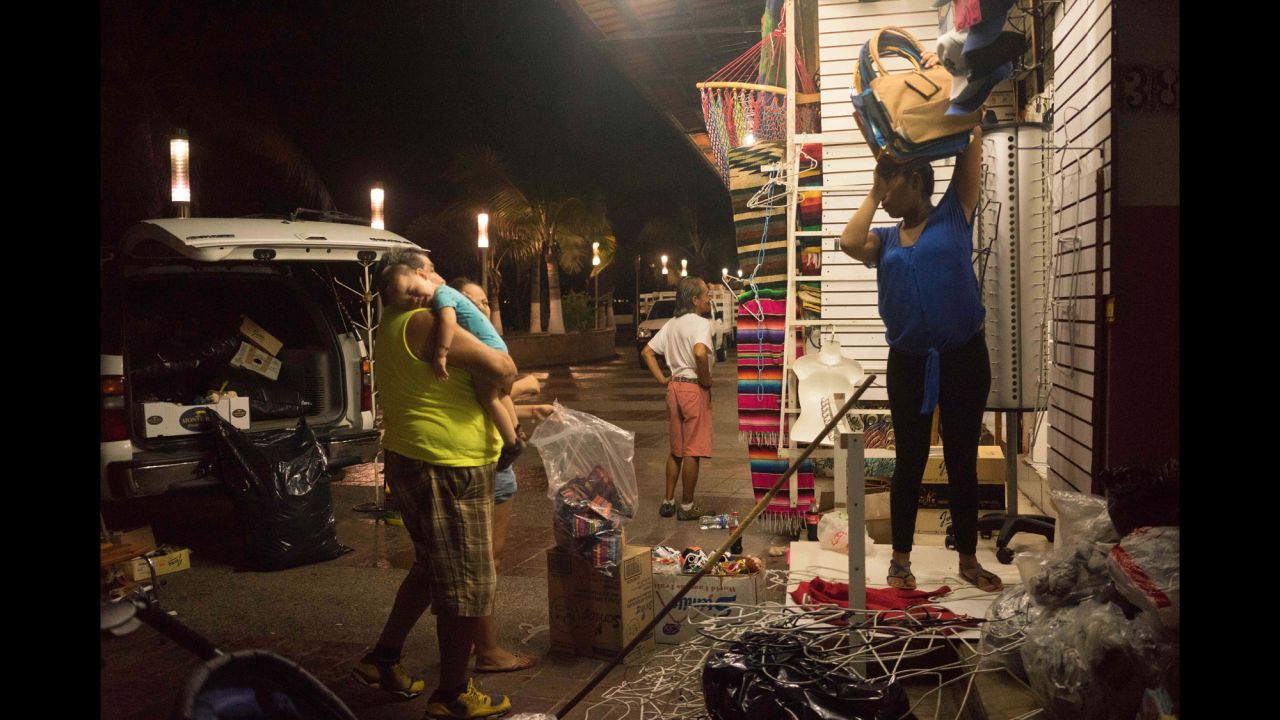 People break down their souvenir shop in Puerto Vallarta on October 22.