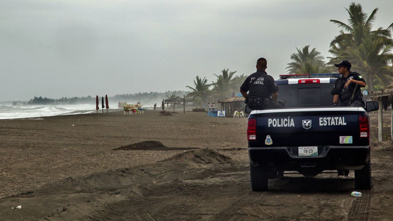 Police patrol the beach in Boca de Pascuales on October 22.