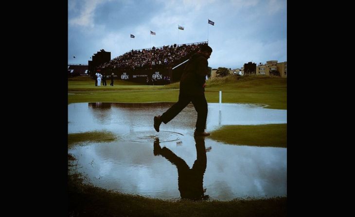CNN's <a href="index.php?page=&url=https%3A%2F%2Finstagram.com%2Fmurpho2005%2F" target="_blank" target="_blank">Chris Murphy </a>captured this shot at St. Andrews soon after the deluge. The gray skies and man skipping through the puddle illustrate just how quickly the rain fell and waterlogged the course. "A tad wet at St Andrews on Friday. All adds to the fun, when you're sitting in the warm & toasty media center anyway," he said.