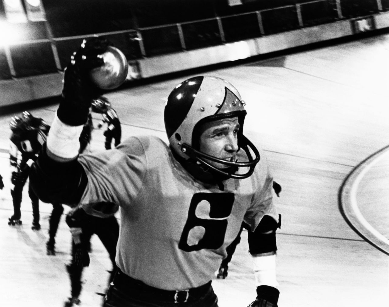 "Rollerball" (1975) stars James Caan as an elite athlete in 2018. Corporations run the world, and everything is calm and luxurious -- except the sport of Rollerball, which lets the public vent its bloodlust. They love Caan's character, but the ruling executives aren't fond of his individualism.