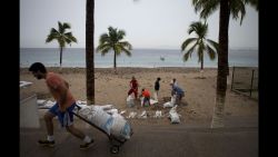 Residents fill sand bags to protect beachfront businesses in Puerto Vallarta on October 23.
