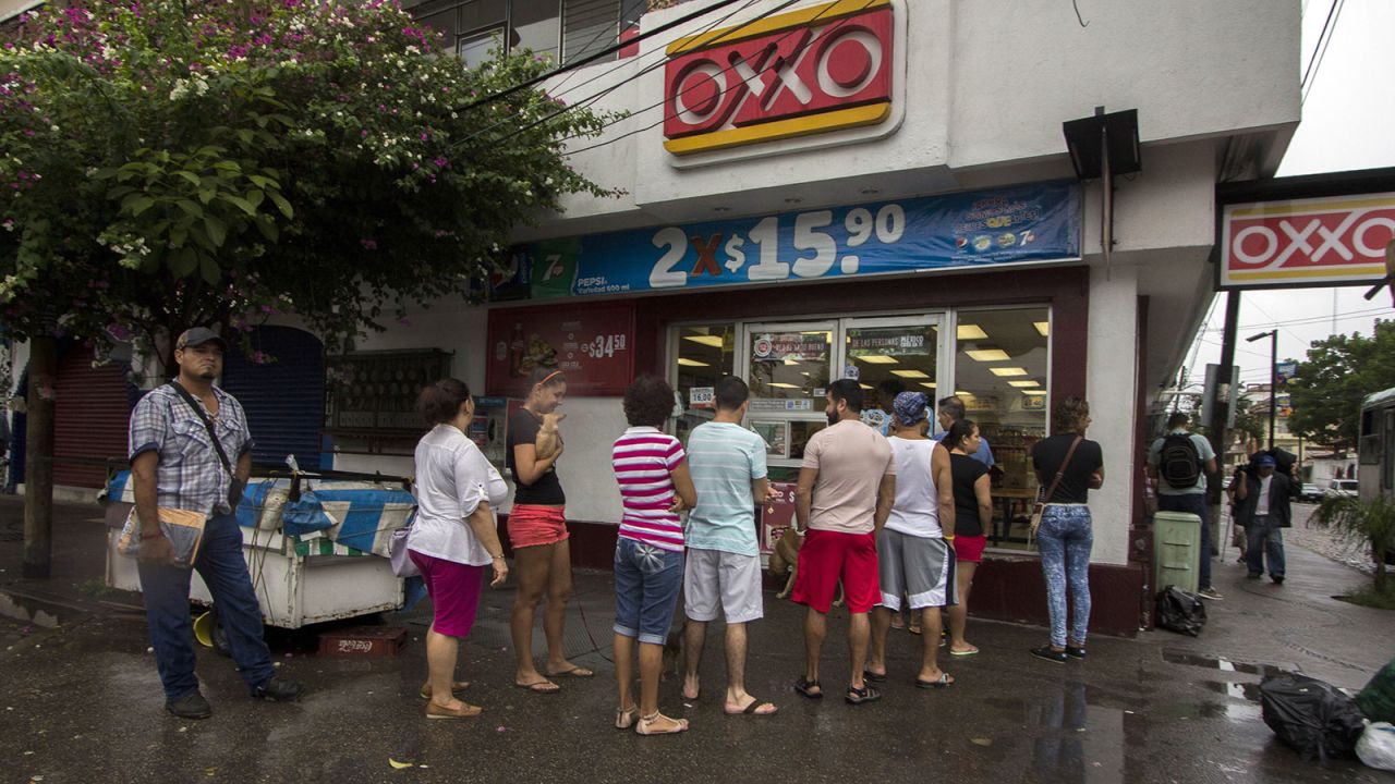 People line up to buy food and water in Puerto Vallarta on October 23.