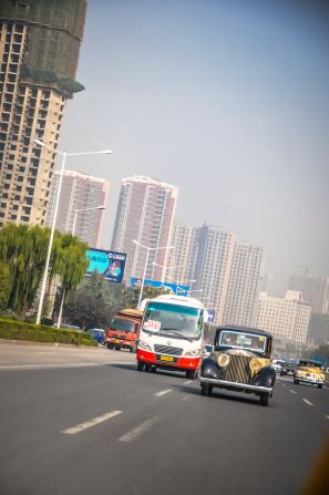 We see huge, high rise buildings. It's dusty along the roads.<br />