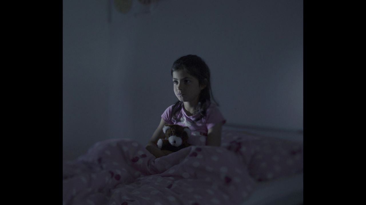 Fatima, 9, sits in bed in Norberg, Sweden. Every night, she said, she dreams that she's falling from a ship. After two years at a refugee camp in Lebanon, Fatima and her family boarded an overcrowded boat in Libya. On the deck of the boat, a woman gave birth to her baby after 12 hours in the scorching sun. The baby was stillborn and thrown overboard. Fatima saw everything. When their boat started to take on water, they were picked up by the Italian Coast Guard.
