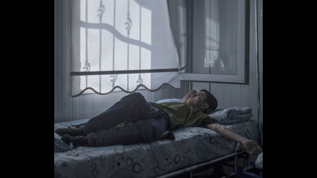 Mohammed, 13, lies in a hospital bed in Nizip, Turkey. Back home in Aleppo, Syria, he used to enjoy walking around the city looking at houses. Now many of his favorite buildings are gone, blown to pieces. Lying in his bed, Mohammed wonders whether he will ever fulfill his dream of becoming an architect. "The strangest thing about war is that you get used to feeling scared. I wouldn't have believed that," he said.