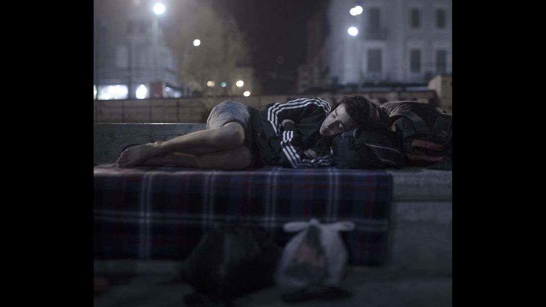 Abdul Karim Addo, 17, sleeps in Omonoia Square in Athens, Greece. He has no money left. He bought a ferry ticket to Athens with his last euros. Now he spends the night where hundreds of refugees are arriving every day. He is able to borrow a telephone and call home to his mother in Syria, but he is not able to tell her how bad things are. "She cries and is scared for my sake, and I don't want to worry her more," he said. He unfolds his blanket in the middle of the square and curls up in the fetal position. "I dream of two things: to sleep in a bed again and to hug my younger sister."