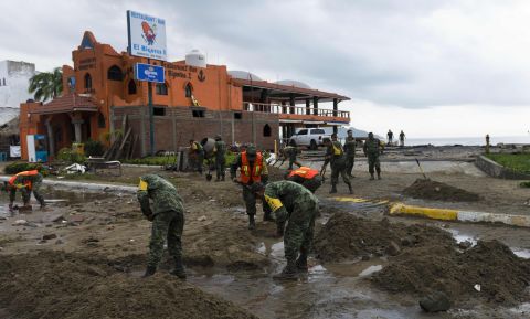 Mexican soldiers remove sand from the street in Manzanillo, Colima state, on Saturday, October 24, after Hurricane Patricia hit the coast of neighboring Jalisco state. 