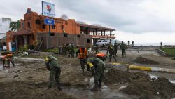 Mexican soldiers remove sand from the street in Manzanillo, state of Colima, after Hurricane Patricia hit the shore of neighbouring Jalisco state, on October 24, 2015. Record-breaking Hurricane Patricia weakened to a tropical storm over north-central Mexico on Saturday, dumping heavy rain that triggered flooding and landslides but so far causing less damage than feared.   AFP PHOTO/OMAR TORRES        (Photo credit should read OMAR TORRES/AFP/Getty Images)