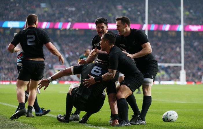 Jerome Kaino of the All Blacks is congratulated by Aaron Smith after scoring the opening try of the semifinal match against South Africa.