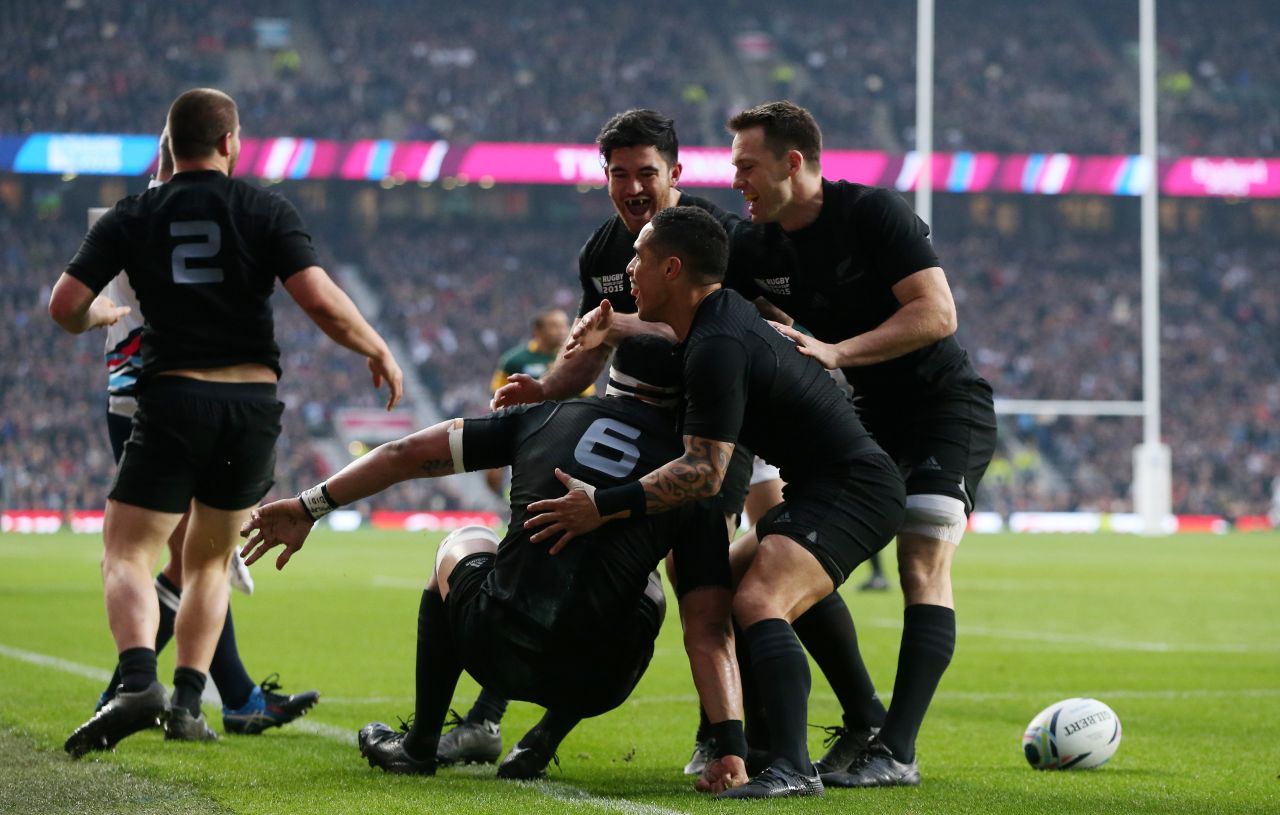 Jerome Kaino of the All Blacks is congratulated by Aaron Smith after scoring the opening try of the semifinal match against South Africa.  