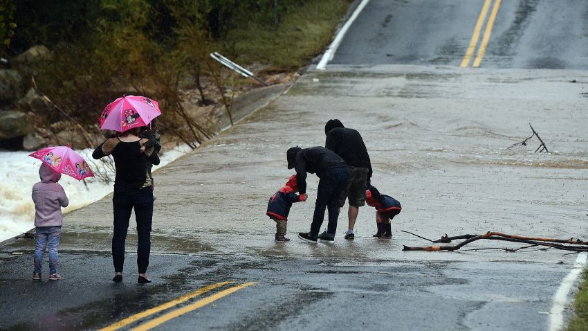 Local residents watch a flooded street in Austin, Texas, on October 24, 2015. Torrential rains created transit mayhem in the US state of Texas on October 24, including a train derailment and scores of canceled flights at one of the nation's busiest airports. AFP PHOTO/JEWEL SAMAD        (Photo credit should read JEWEL SAMAD/AFP/Getty Images)